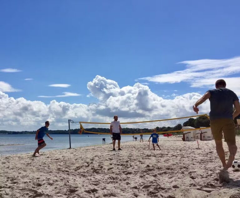 Ostseecamp Gluecksburg Holnis Gaeste spielen Beachvolleyball auf dem Campingplatzgelaende an der Ostsee 768x634